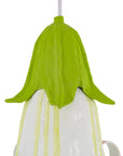 Decorative light with green top and white base on a white background