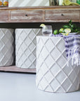 stylish stool/accent table clad in papier mache on porch