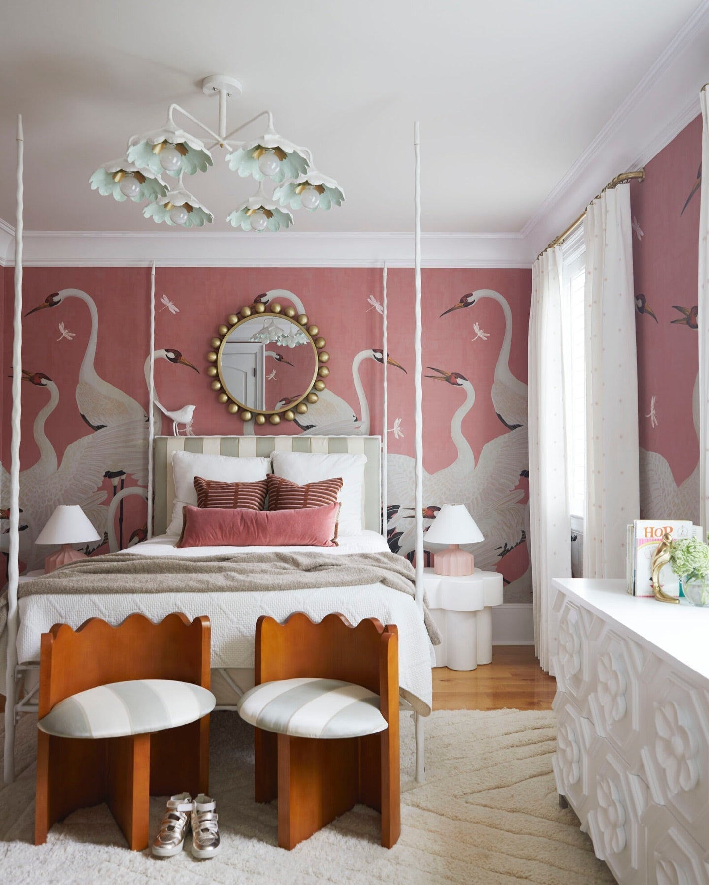 floral bedroom ceiling light with bold pink and white wallpaper mural of white storks