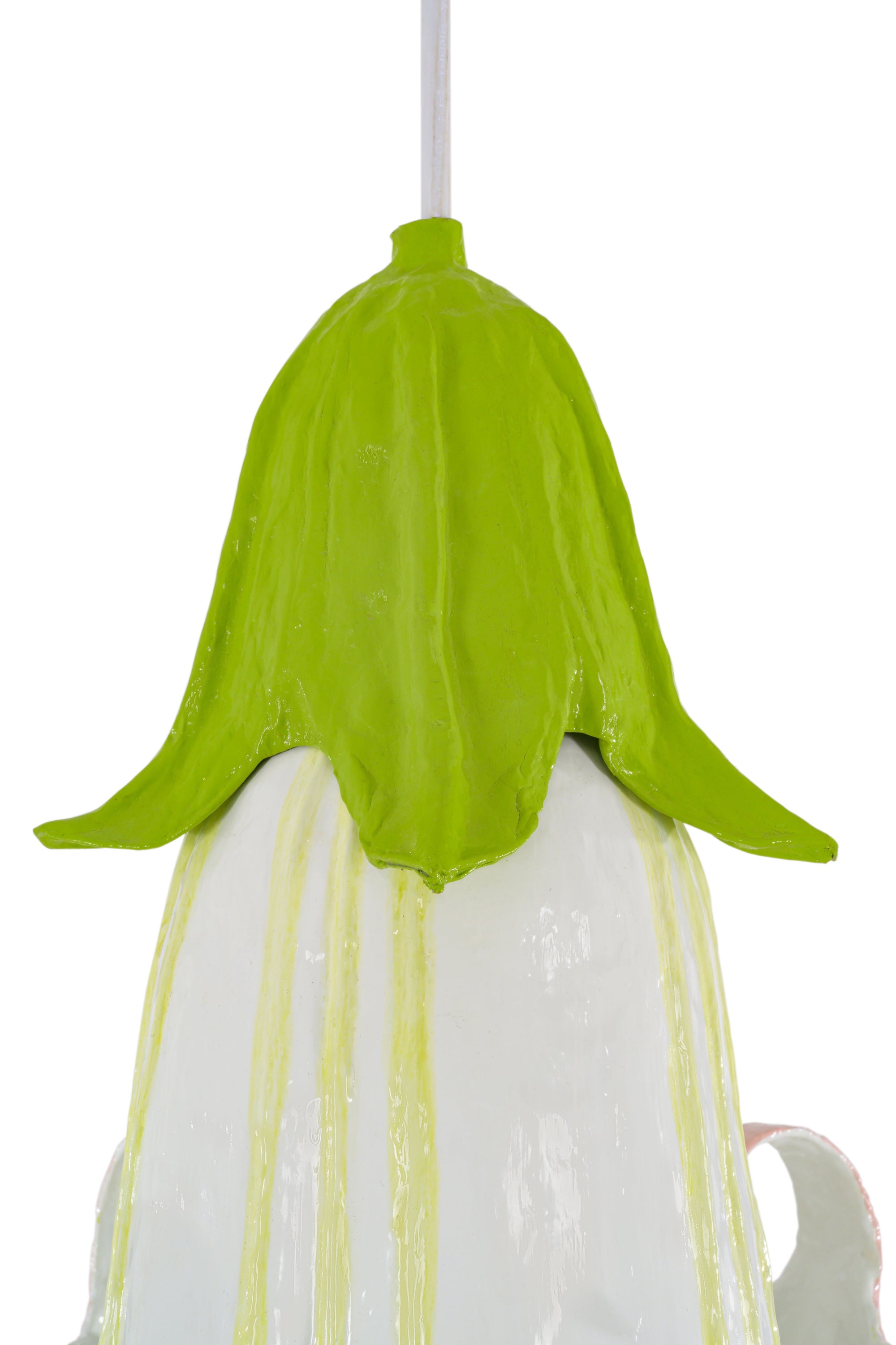 Decorative light with green top and white base on a white background
