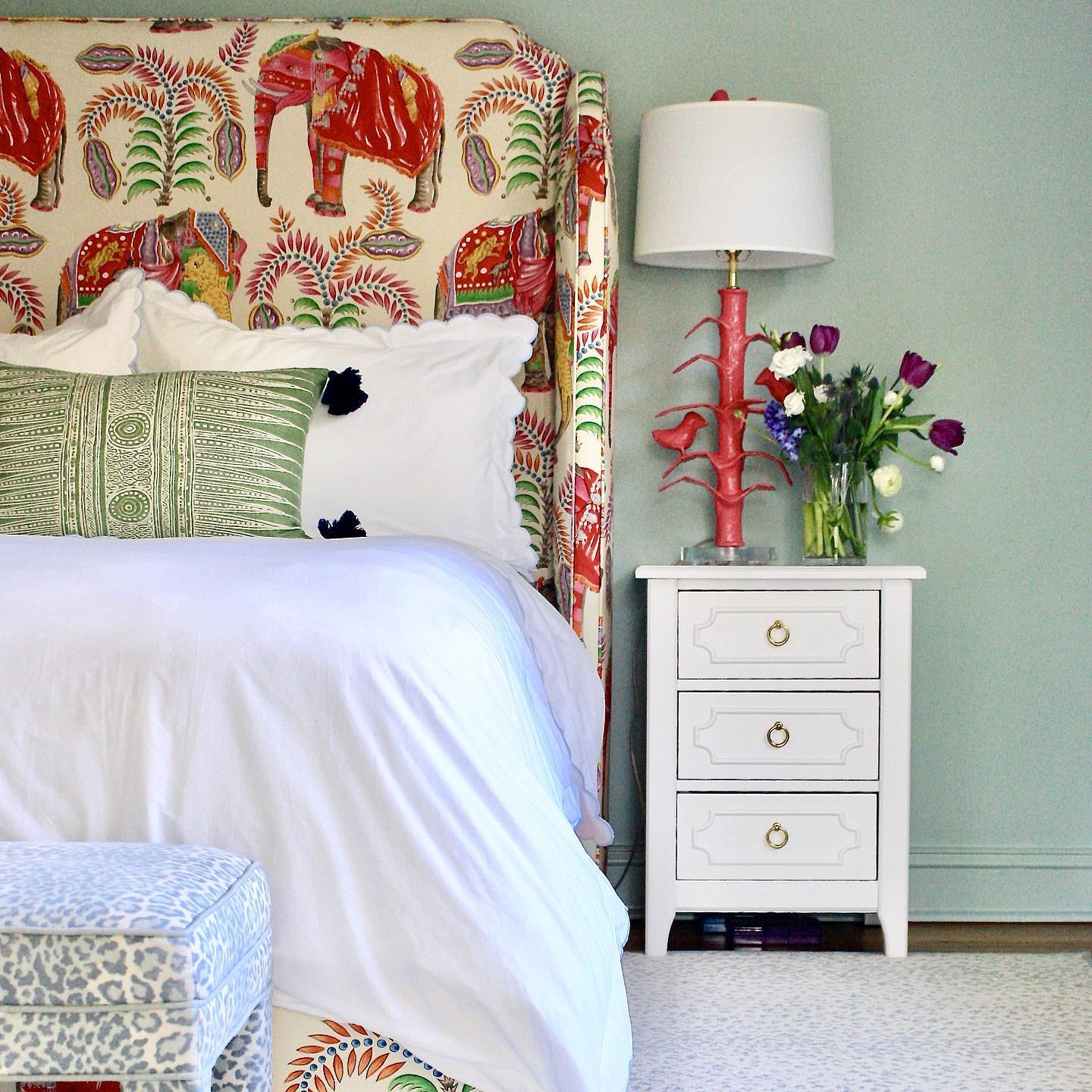 sarah table lamp by stray dog designs, a bird table lamp that in red next to patterned headboard 