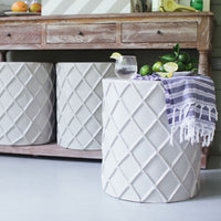 stylish stool/accent table clad in papier mache on porch