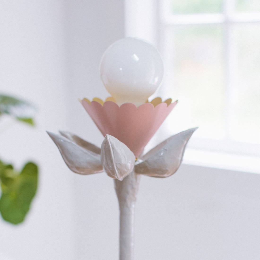booper lamp by stray dog designs with papier mache petals and an exposed bulb.