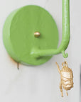 James wall sconce with dangling gold bug, green papier mache and iron