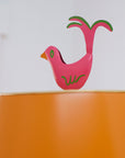 Stray Dog Designs scalloped shade in orange, pink bird finial